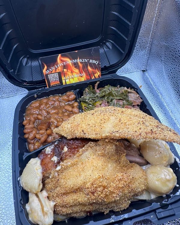 Plate of fried catfish, ribs, shells and cheese, baked beans, and collard greens